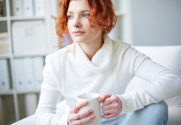 Pensive woman with a white sweater  Photo |  Download