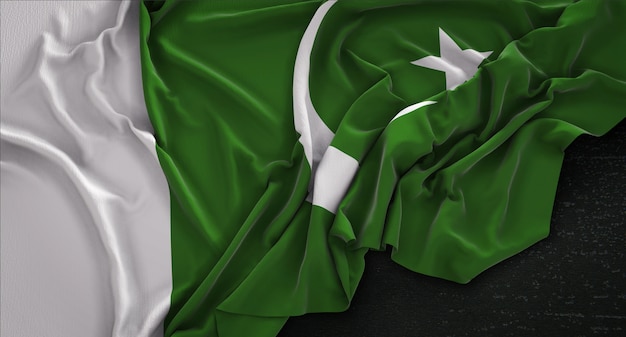 Photo | Pakistan flag wrinkled on dark background 3d render